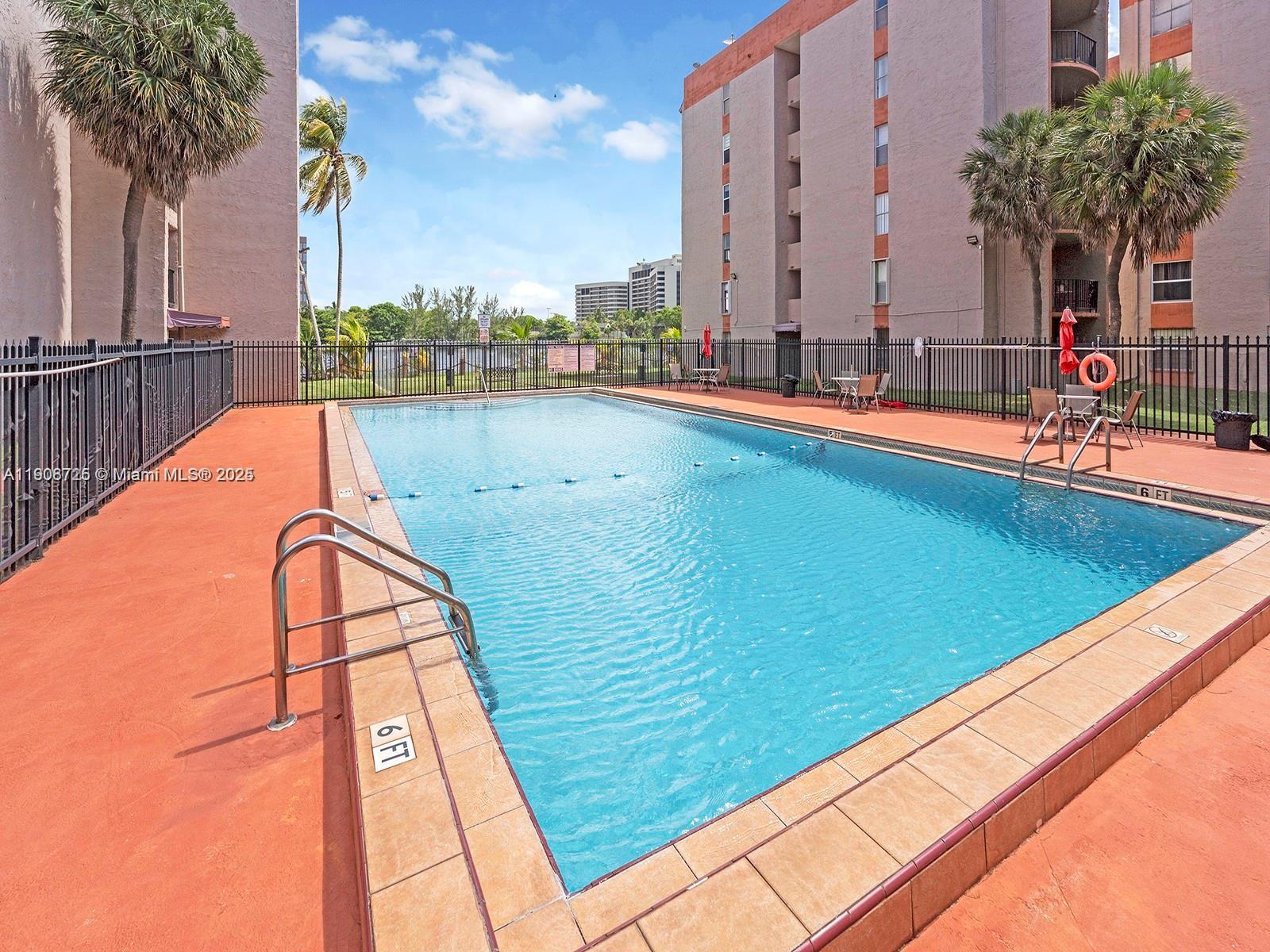 5201 Northwest 7th Street, Unit 106 Miami, FL 33126 - Photo 17 of 20 a view of a swimming pool with a terrace
