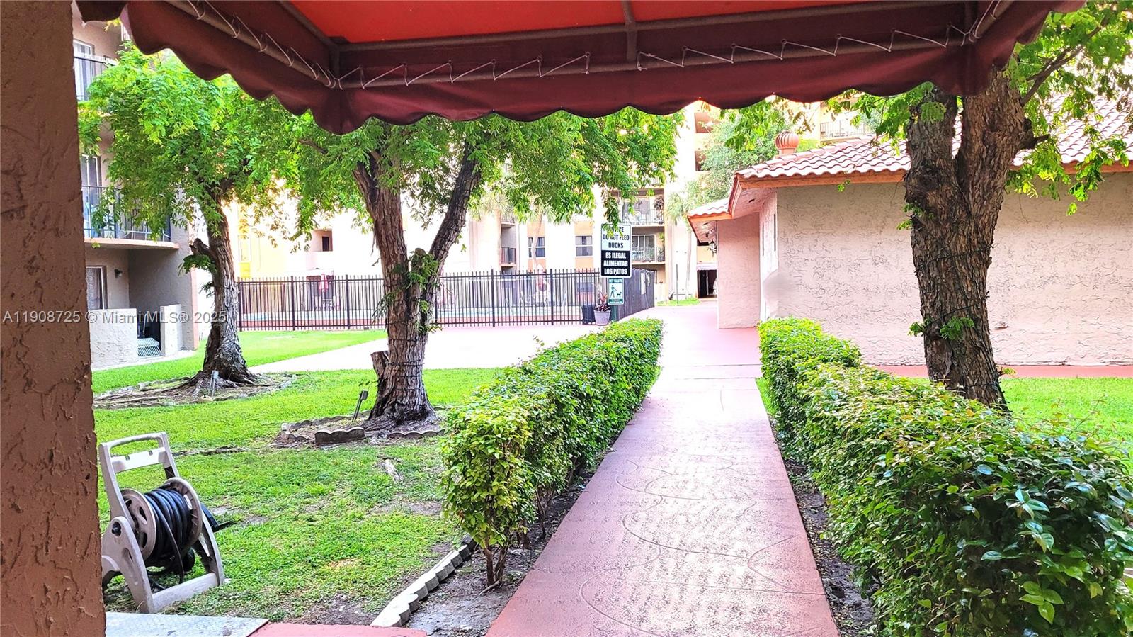 5201 Northwest 7th Street, Unit 106 Miami, FL 33126 - Photo 18 of 20 a view of a garden with pathway