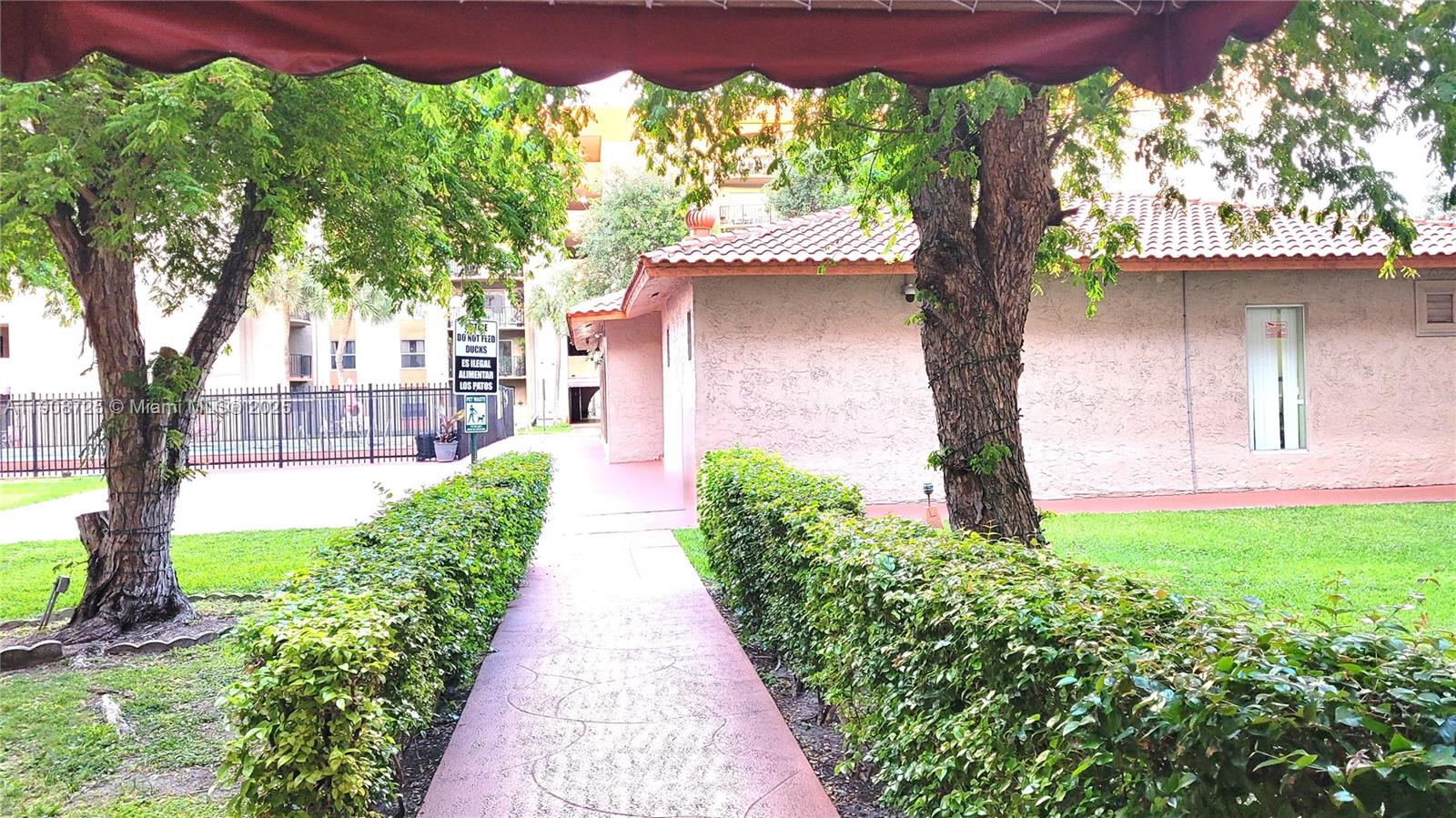 5201 Northwest 7th Street, Unit 106 Miami, FL 33126 - Photo 19 of 20 a front view of a house with a yard