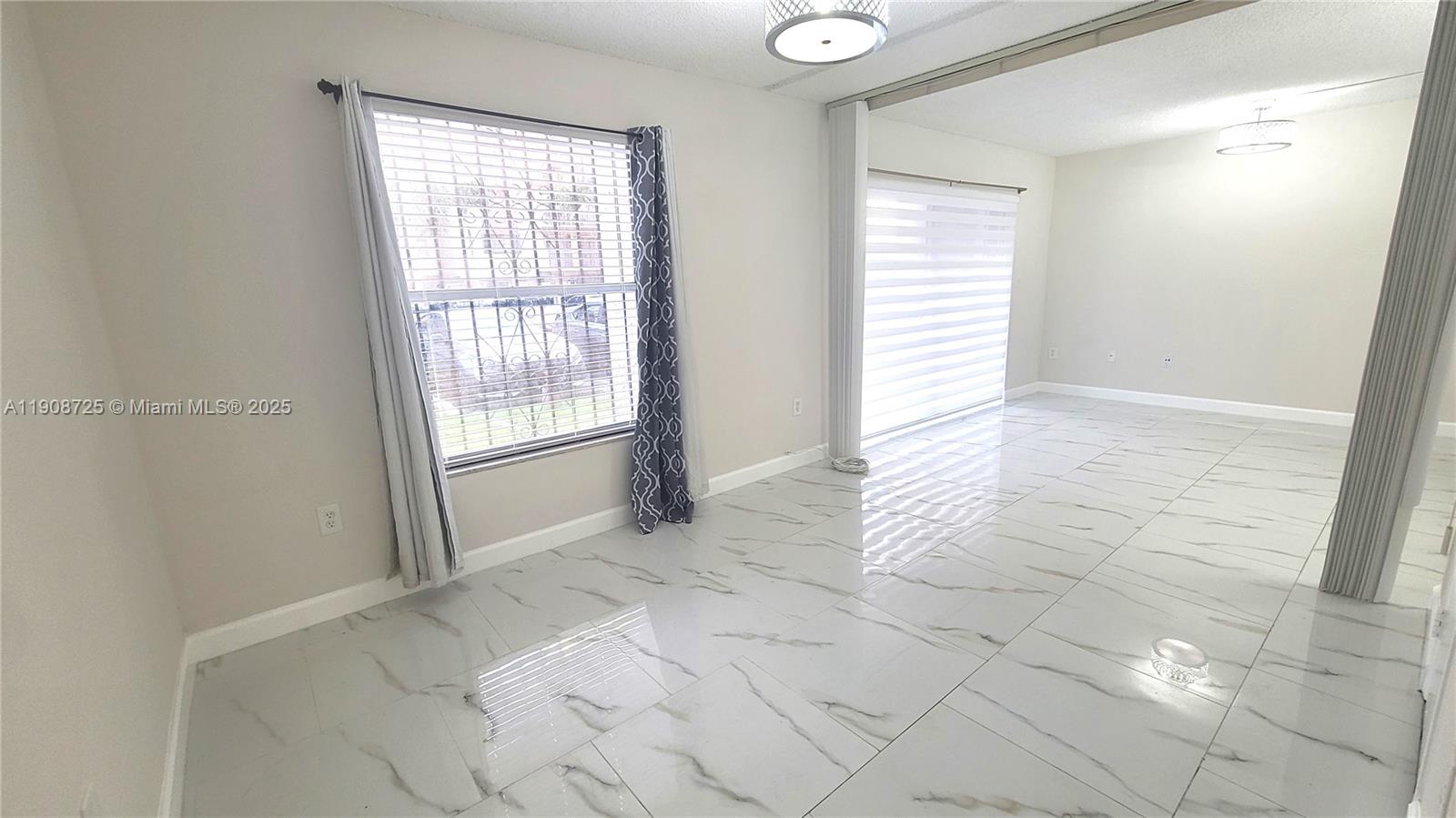 5201 Northwest 7th Street, Unit 106 Miami, FL 33126 - Photo 10 of 20 a view of an empty room and window