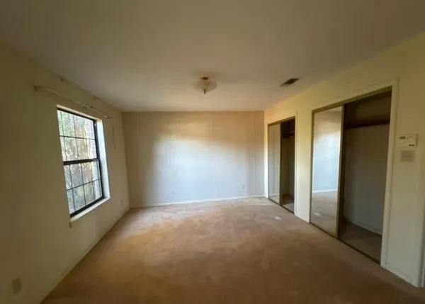 a view of empty room with windows