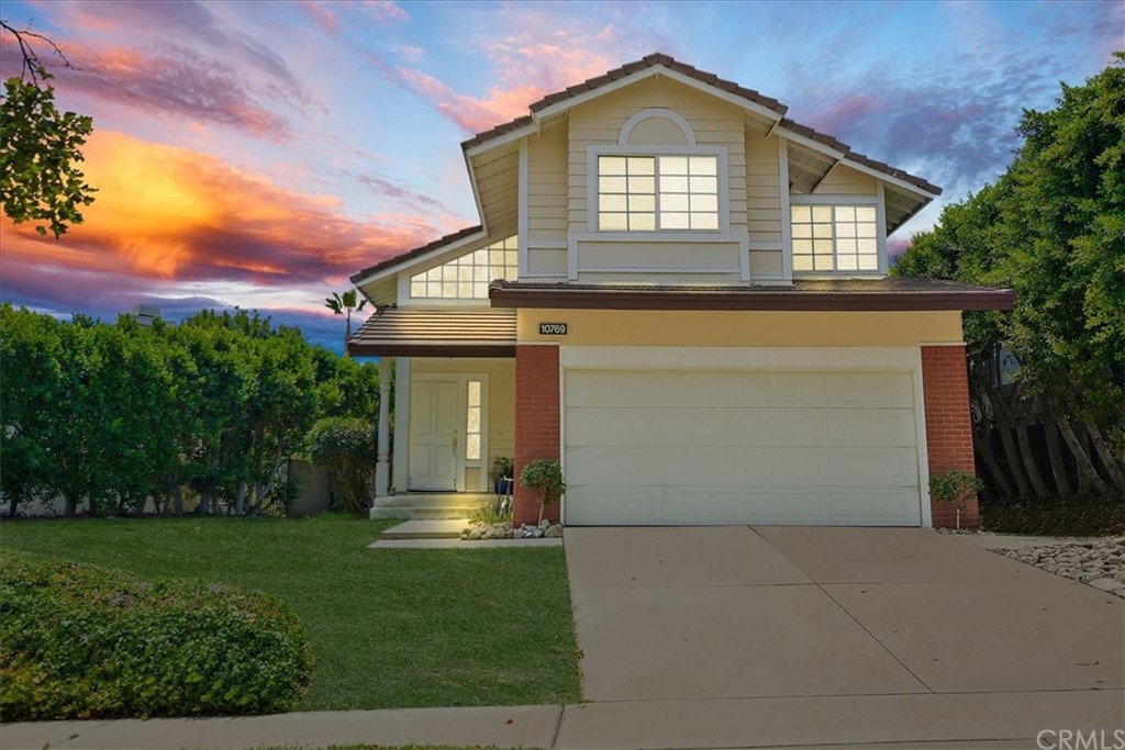 10769 Champagne Road Rancho Cucamonga, CA 91737 - Photo 1 of 1 front view of a house with a yard