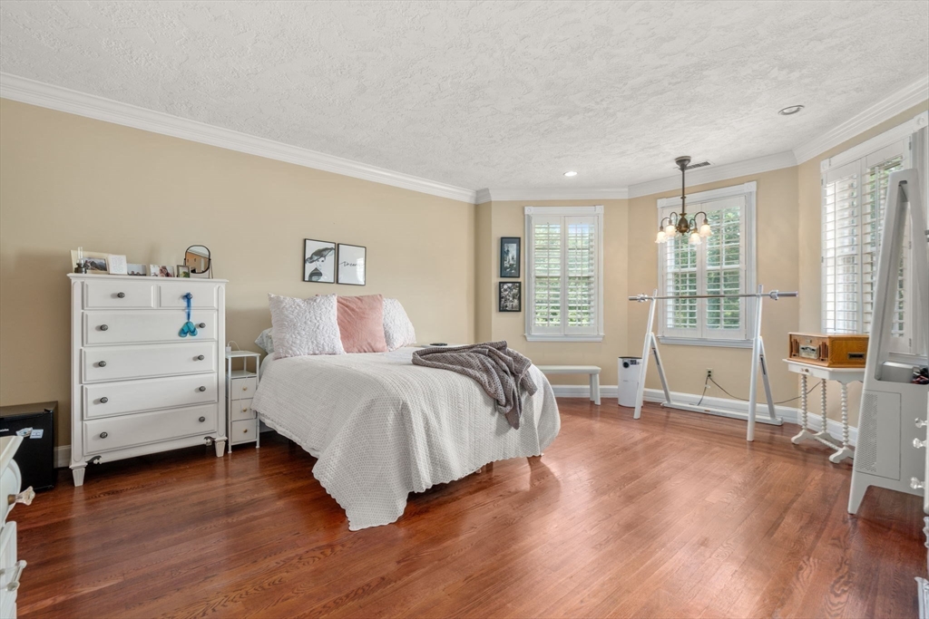 2 Country Way Hopkinton, MA 01748 - Photo 22 of 38 a spacious bedroom with a bed and wooden floor