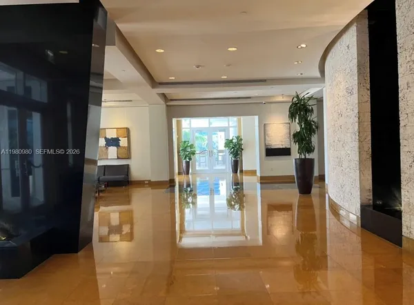 a hallway with a view of living room with balcony
