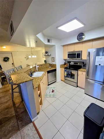 a living room with couches and kitchen view