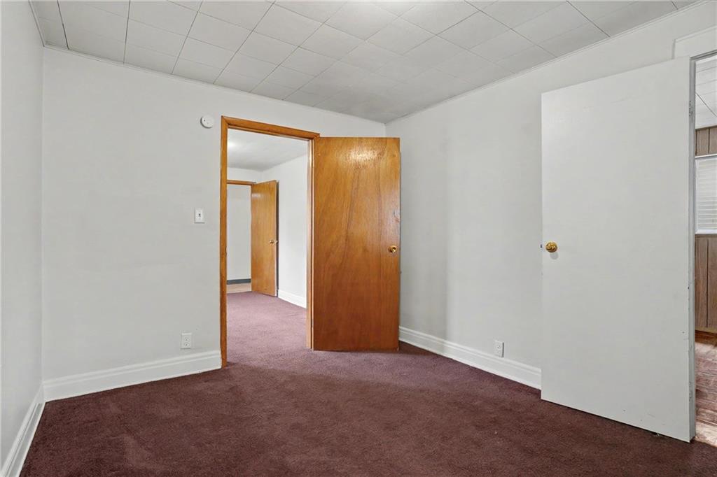 218 Vine Street Homestead, PA 15120 - Photo 13 of 36 a view of an empty room with a fireplace