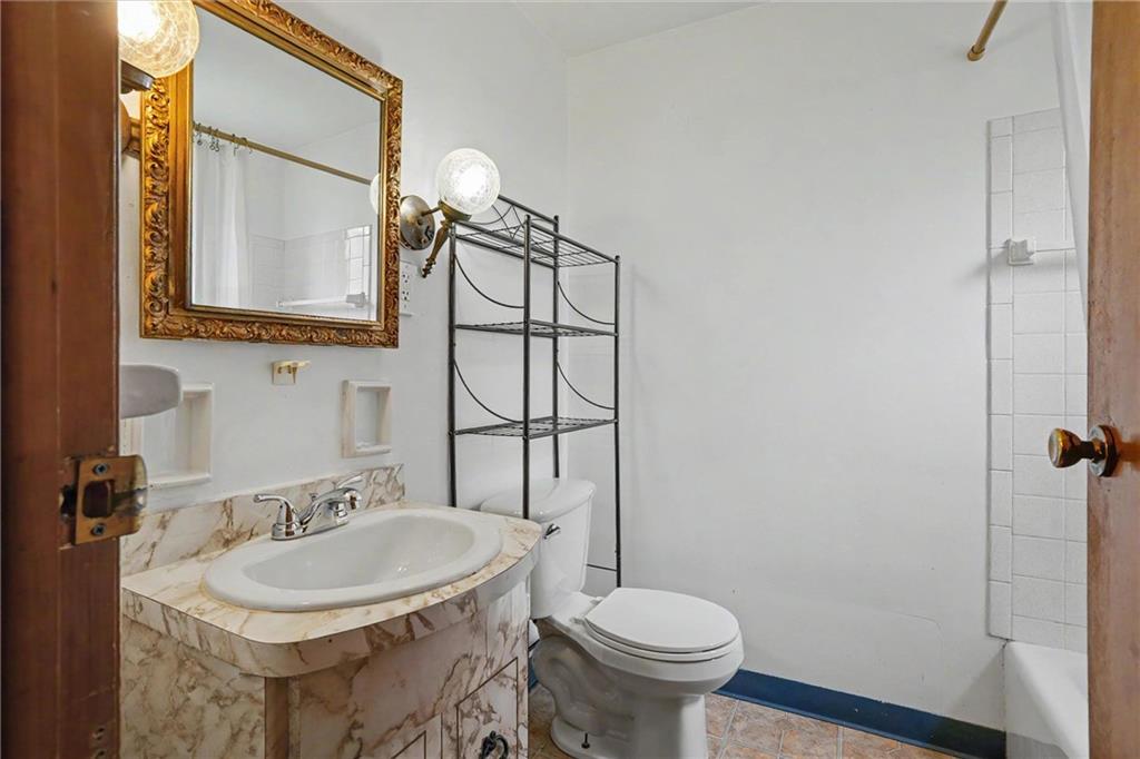 218 Vine Street Homestead, PA 15120 - Photo 18 of 36 a bathroom with a sink and mirror with toilet