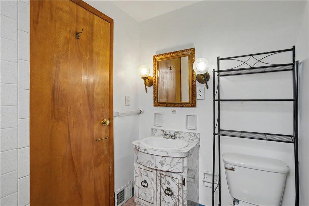 218 Vine Street Homestead, PA 15120 - Photo 20 of 36 a bathroom with a sink and a mirror
