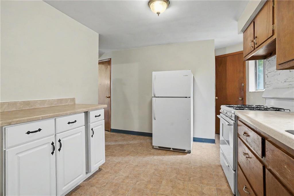 218 Vine Street Homestead, PA 15120 - Photo 9 of 36 a kitchen with a refrigerator and a stove