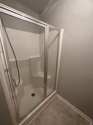 a bathroom with a glass shower door