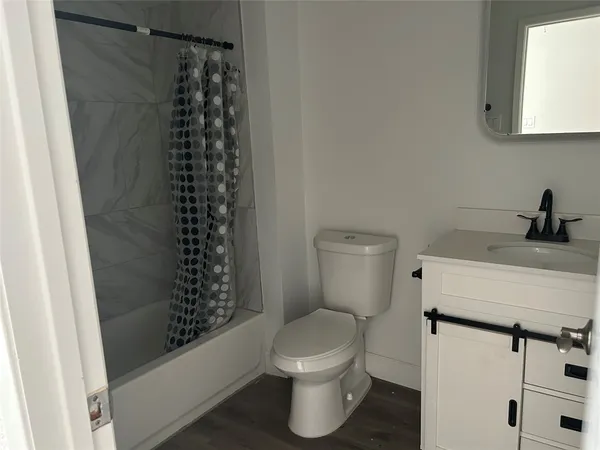 a view of a house with wooden fence