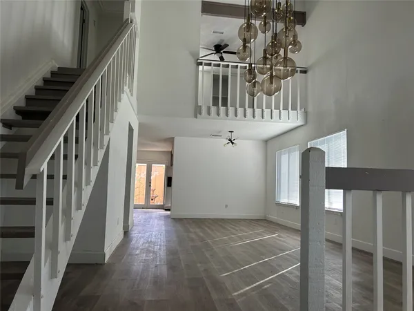 a view of entryway and hall with wooden floor