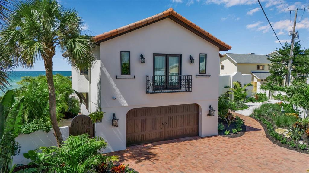 121 North Casey Key Road Osprey, FL 34229 - Photo 56 of 63 a front view of a house with garden
