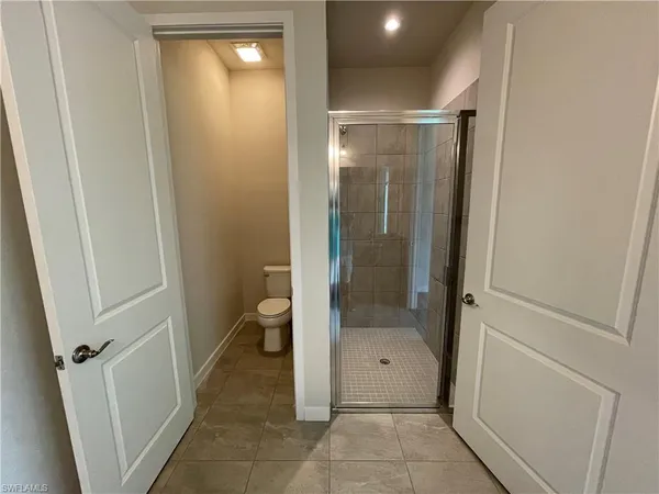 a bathroom with a granite countertop shower and a sink