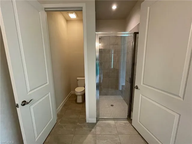 a bathroom with a granite countertop shower and a sink