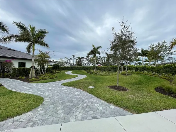 a view of a garden with a house
