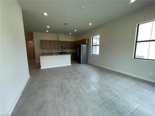 a view of a kitchen with a sink and a window