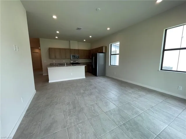 a view of a kitchen with a sink and a window