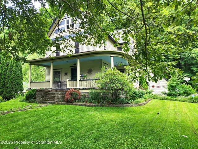 a view of a house with a yard and plants