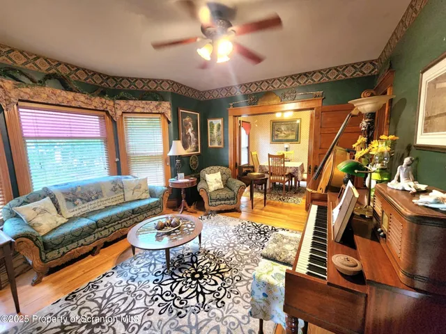a dining room with furniture and wooden floor
