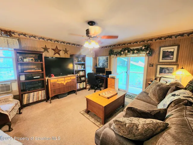 a bathroom with a toilet and a painting on the wall