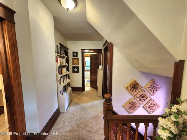 a bedroom with a bed and dresser with mirror