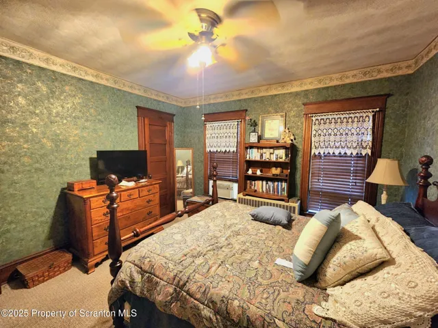 a bedroom with furniture and a rug