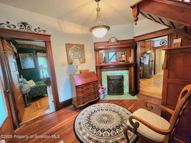 a living room with furniture a fireplace and a table