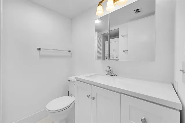 a bathroom with a sink a toilet and mirror