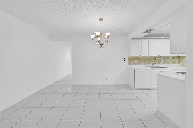 a view of a kitchen with cabinet and a chandelier