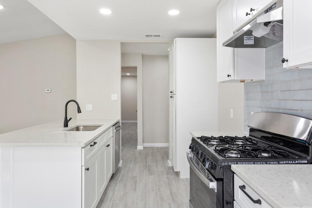 9604 Crown Ridge Road Austin, TX 78753 - Photo 4 of 24 A well-appointed kitchen features modern appliances and elegant countertops, offering functionality and style.