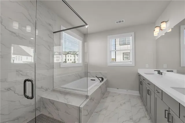 a spacious bathroom with a double vanity sink mirror and shower