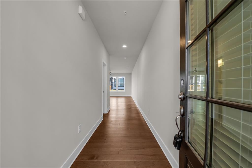 1230 Weatherway Lane Cumming, GA 30041 - Photo 2 of 34 a view of a hallway with wooden floor and staircase