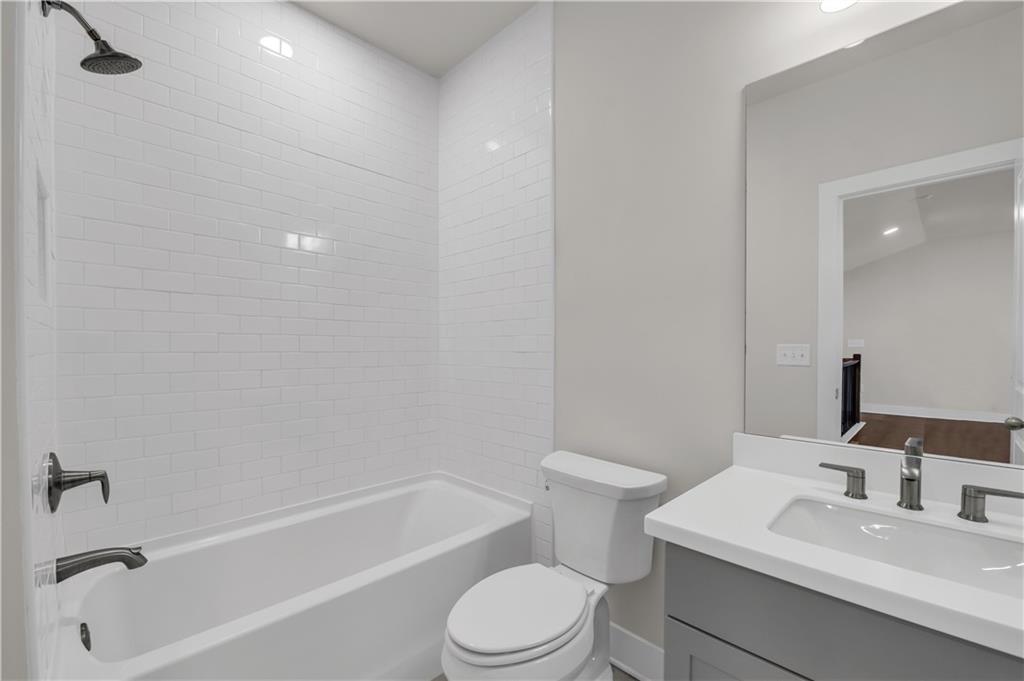 1230 Weatherway Lane Cumming, GA 30041 - Photo 27 of 34 a bathroom with a toilet a sink and a bathtub