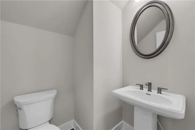 a kitchen with stainless steel appliances granite countertop a stove top oven a sink dishwasher a refrigerator and a dining table with wooden floor