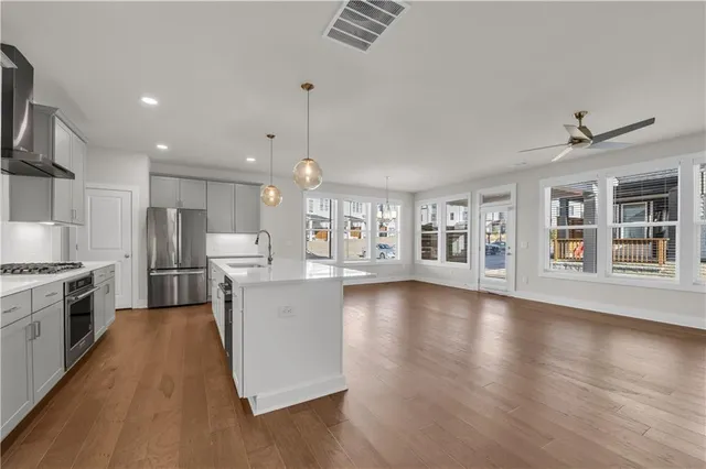 a view of empty room with wooden floor and window