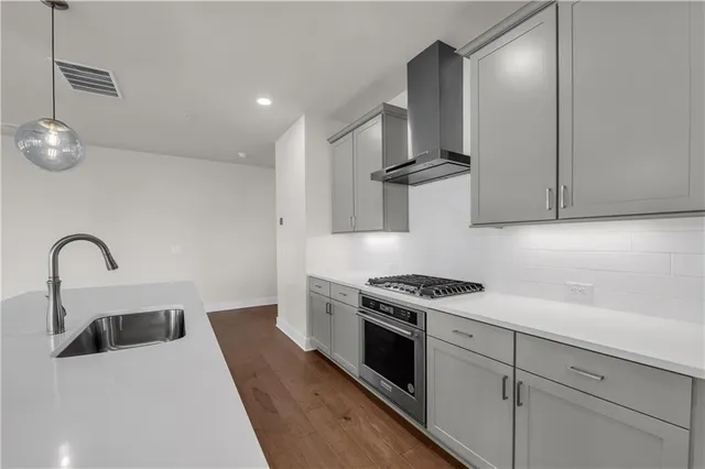 a kitchen with stainless steel appliances granite countertop a sink stove and refrigerator
