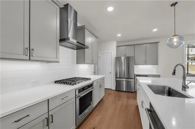 a kitchen with sink and mirror