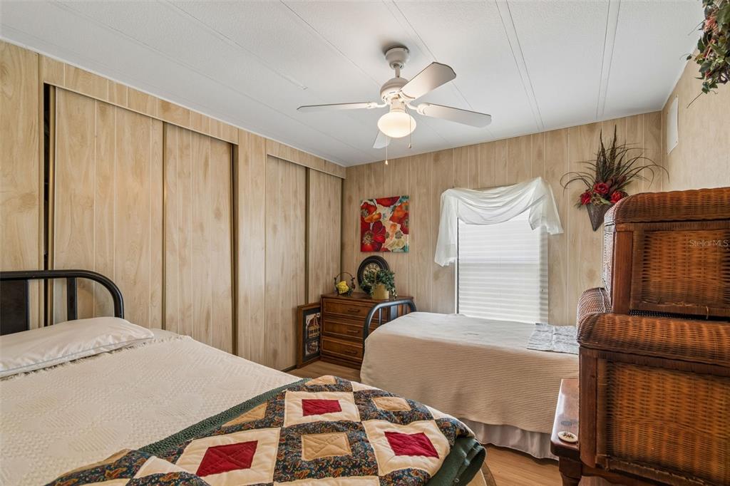 12501 Ulmerton Road, Unit 175 Largo, FL 33774 - Photo 12 of 32 a bedroom with a bed and a chandelier