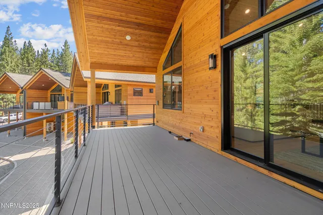 a view of a balcony with wooden floor and door