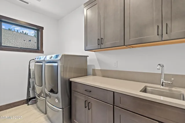 a sink with a refrigerator and cabinets