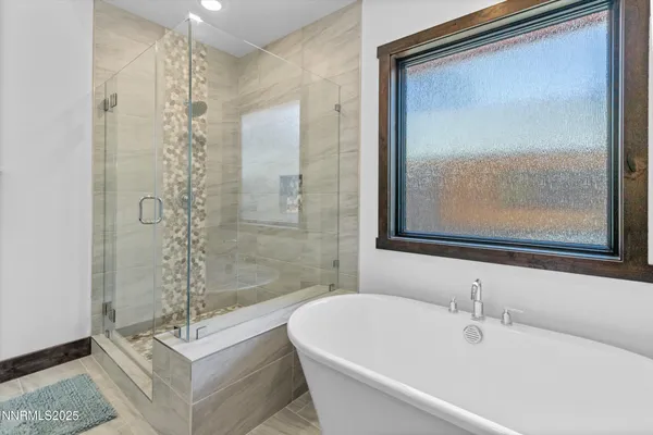 a bathroom with a bathtub and shower