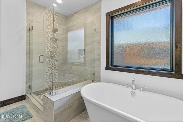 a bathroom with a bathtub and shower