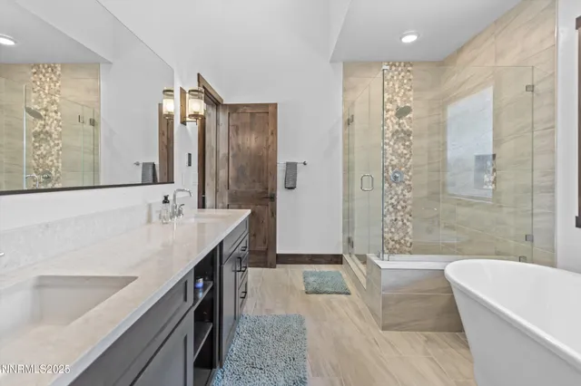 a spacious bathroom with a tub sink and mirror