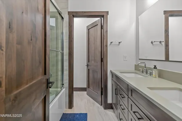a bathroom with a sink a mirror and a shower