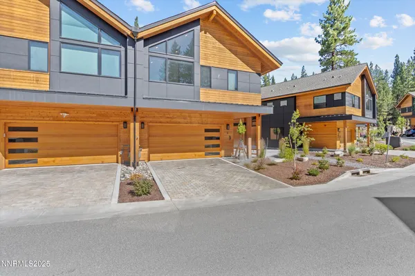 a front view of a house with basket ball court and outdoor seating