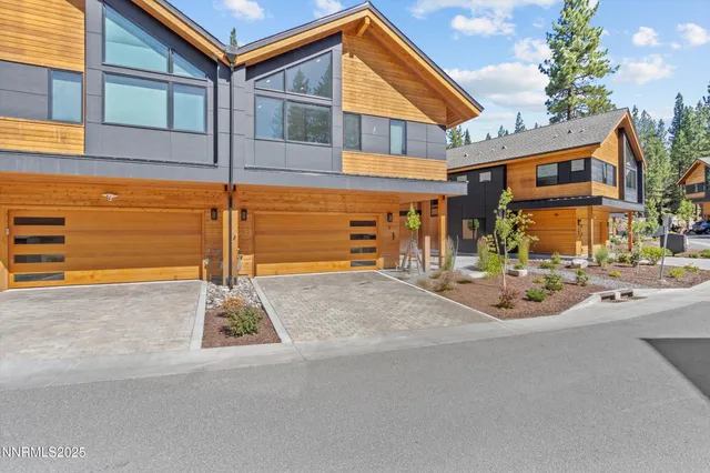 a front view of a house with basket ball court and outdoor seating