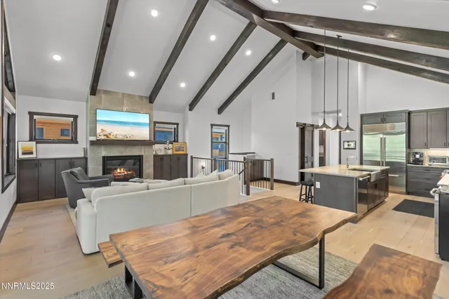 a living room with furniture a fireplace and a table