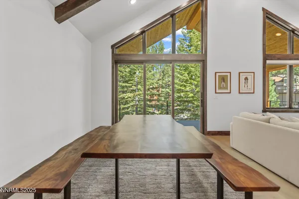 a view of a room with a window and furniture
