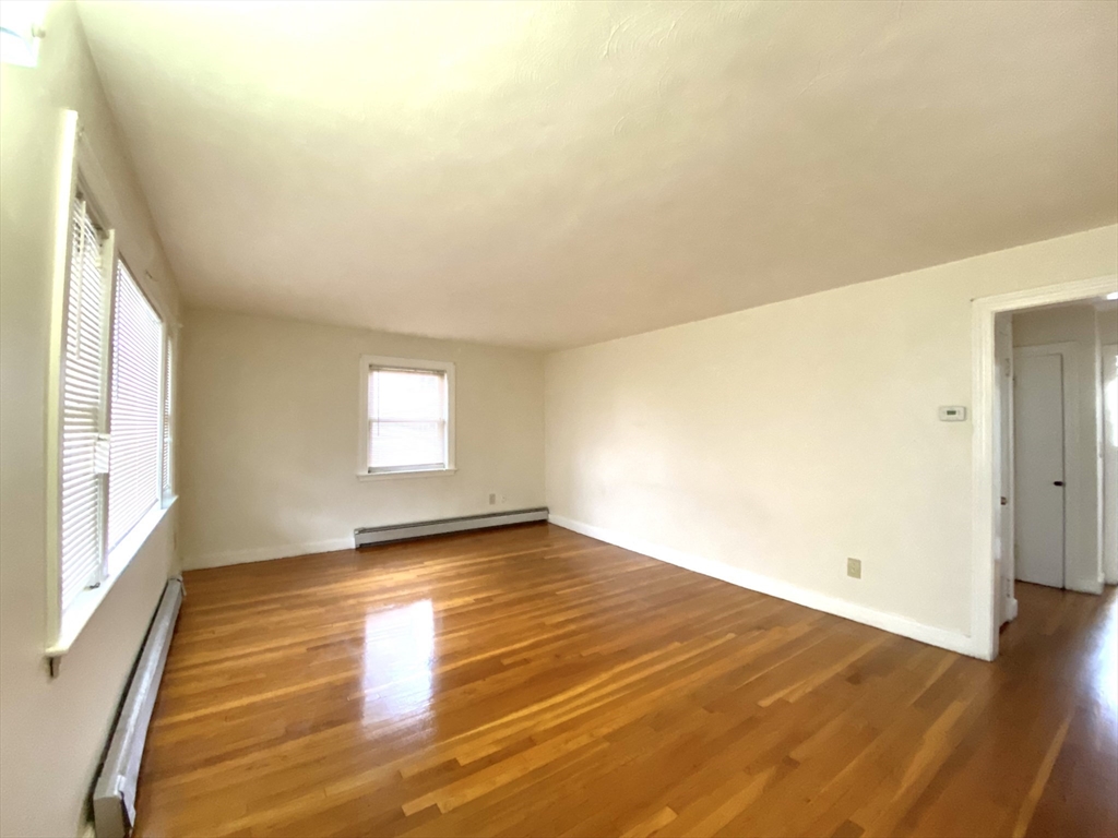 530 Beach Street, Unit 2 Revere, MA 02151 - Photo 2 of 7 a view of empty room with wooden floor and fan